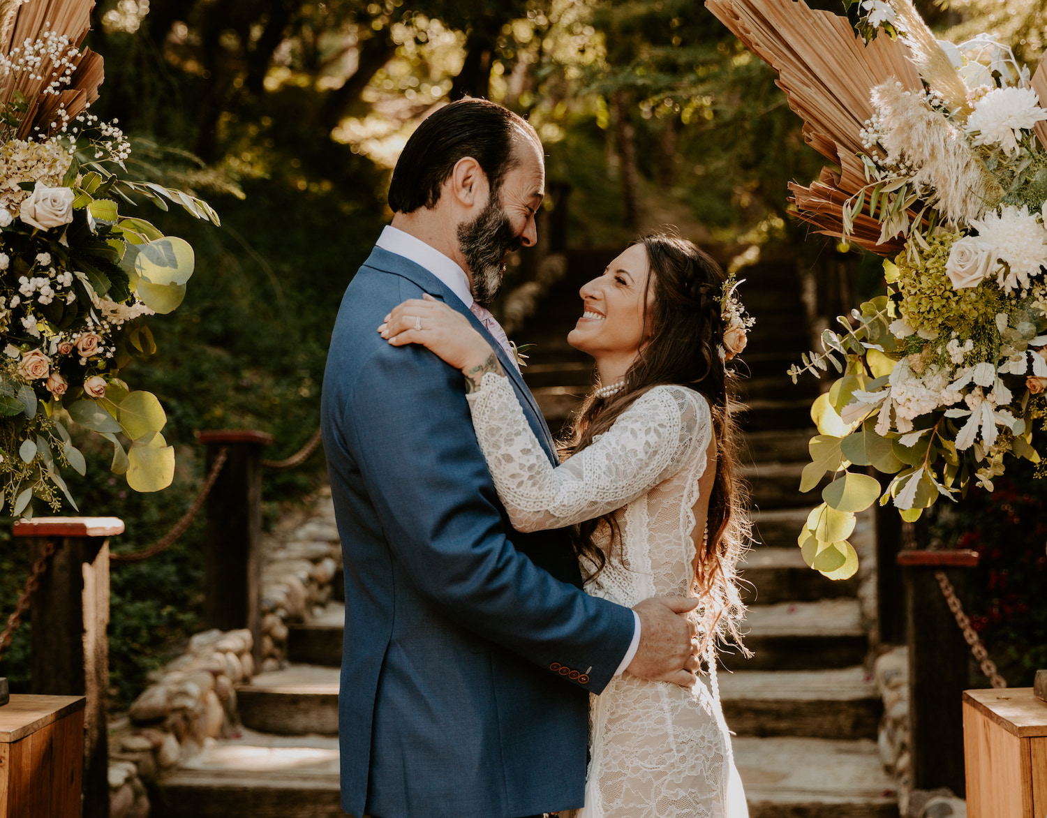 A couple embrace and smile at each other during their Rancho Las Ramos wedding by Maya Lora Photography