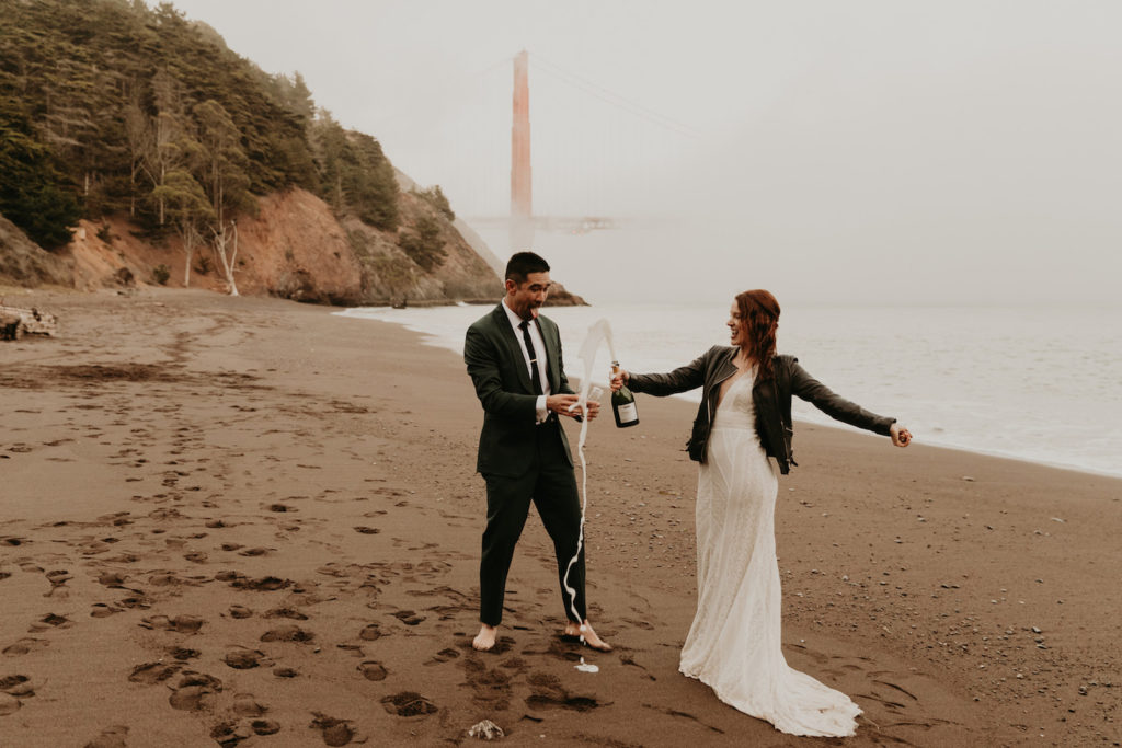 A couple celebrate their engagement on Baker Beach in San Fran